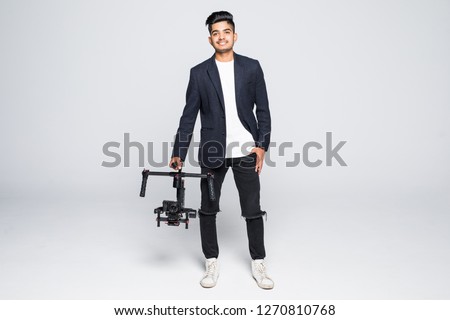 Cameraman holding gimbal with slr camera