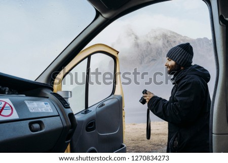 Man with photo camera on remote road
