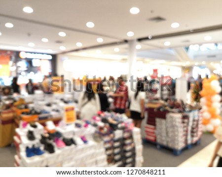 People shopping in department store. Defocused blur background, Shopping Mall, blur with bokeh.