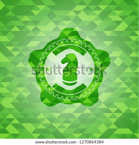 chess knight icon inside realistic green mosaic emblem