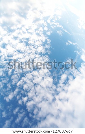 Vertical image of blue sky with clouds