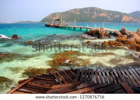 Koh kham small island and wood bridge on the beach with blue sky and clear water. Koh kham pattaya thailand.