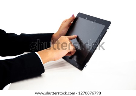 The businesswoman using new tablet pc. Black screen with gelatine and white background. Isolated image.