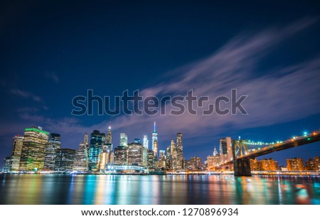 New york city skyline with reflection in water at night.