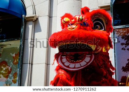 Chinese lion costume dance during Chinese New Year celebration. High-quality stock photo image of Chinese red lion dance costume used during Chinese Lunar New Year celebration
