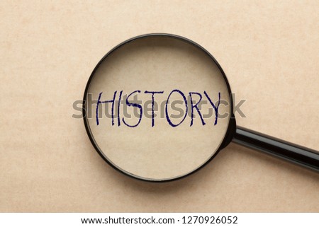 Magnifying glass focusing on HISTORY word. Business concept