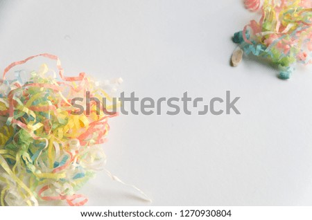 Streamers on a wooden background after coming out of popper