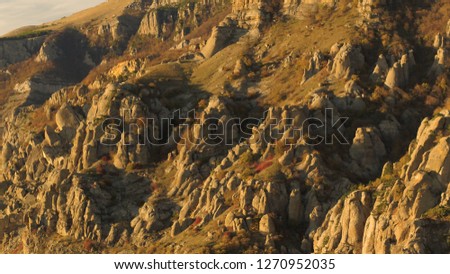 Flying aerial view on Beautiful and huge mountain rock at sunset. Shot. Stones and rocks on mountain background with sunlight