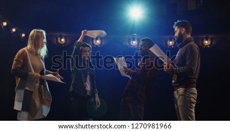 Medium shot of actors and actresses arguing during rehearsal in a theater Royalty-Free Stock Photo #1270981966