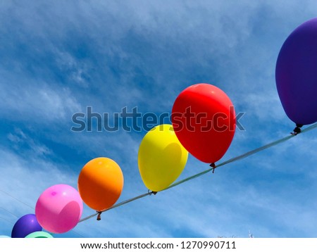 Colorful of balloons on the blue sky background.Decorate party card for design.