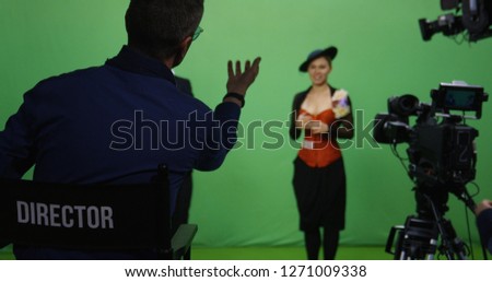 Slow motion shot of a director talking to actor and actress before they perform a scene