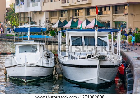 Small Yacht with UAE flag tied to cleats in port Royalty-Free Stock Photo #1271082808