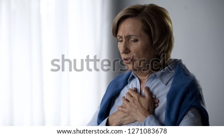 Elderly lady having asthma attack symptoms, hard to breath and pain in chest Royalty-Free Stock Photo #1271083678