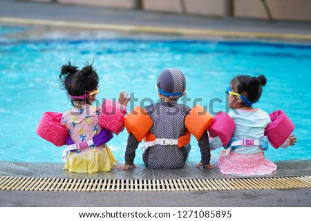 Kids enjoy swimming at the swimming pool.summer vacation and holidays concept  Royalty-Free Stock Photo #1271085895