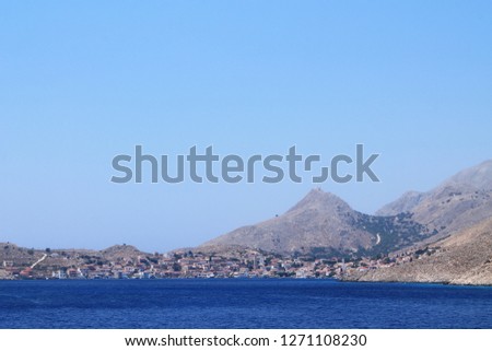 Distant view of the old town and the port of Emporio in Halki Island, a Greek Island near Rhodes Island, Europe