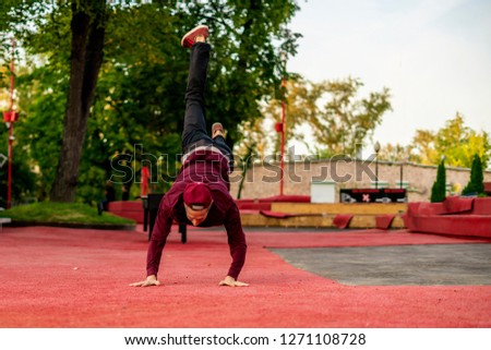 male athlete practising parkour in the street in summer day
