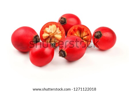 Rosehips ( Rosa Canina fruits ) , one cut in half, isolated on white background. Royalty-Free Stock Photo #1271122018