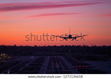 Commercial Passenger jet flying into the sunset Royalty-Free Stock Photo #1271136658