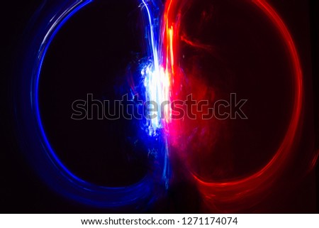 light painting, traces of light, long exposure black background, drawing with light, light rings blue and red, neon lights, 