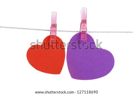 two foam shapes hearts pinned together isolated on white background