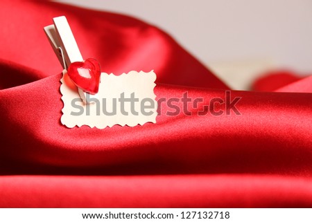 Gift card for Valentine's Day, on a red silk