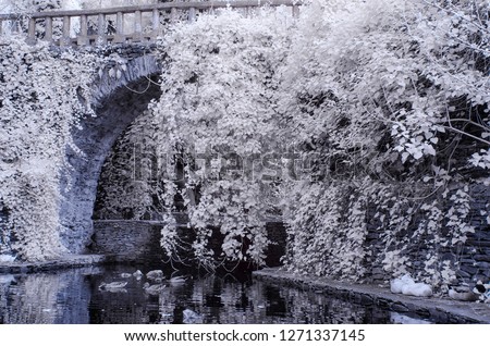 a bridge on river with reflections 720nm infrared photo