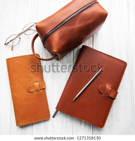 Brown leather accessories on a old wooden table
