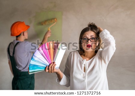 Woman confused by the colour of the wall