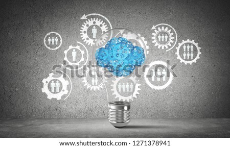 Lightbulb with cloud from gears inside placed against social gear structure on grey wall. 3D rendering.