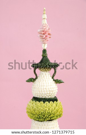 Banana leaf folding and flower decorated on the tray with pedestal in Thai traditional style and close up.