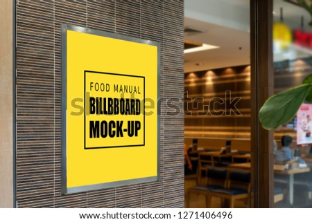 Mock up perspective blank yellow screen signboard for promotion menu frame near entrance of restaurant with clipping path and blurred people in background, empty space for advertising or information


