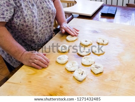 pictured in the photo woman makes patties with minced yeast dough