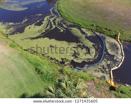 Drone aerial photo of an algae bloom in a polluted retention pond