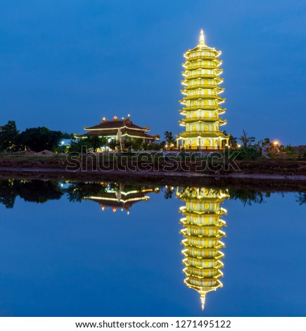 A high quality picture of Dai Giac pagoda in Dong Hoi city, Quang Binh province, Vietnam mirror on the river