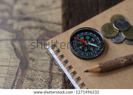 Vintage tone compass, coin, key and map, antique travel concept, copy space