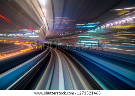Motion blur of a city and tunnel from inside a moving monorail in Tokyo. Abstract motion speed railway tunnel with city background Royalty-Free Stock Photo #1271521465