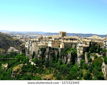 The photo is of a beautifull village in Spain. The name of the village is Cuenca. Cuenca is known by his hanging houses (you can see one on the picture). 