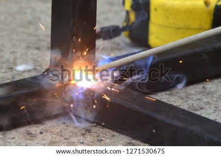Spark from weld work when welder welding an iron, steel structure in a construction site, industrial metal workshop in a factory