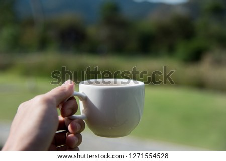 vacation time with black coffee morning on green field