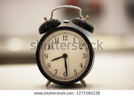 the black clock shows half past eight Royalty-Free Stock Photo #1271586238