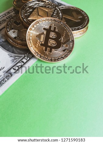 Crypto currency coins, Z cash, Monero, Ethereum and Bitcoin on a Dollar bill on a green background