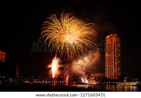 New year celebrate,  crowd and colorful fireworks near the river, Thailand
