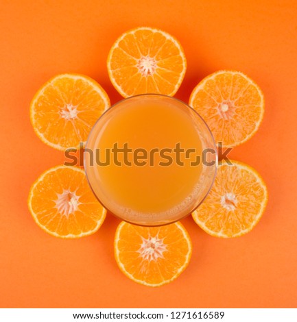 Orange Juice isolated on Orange background. top view, composition