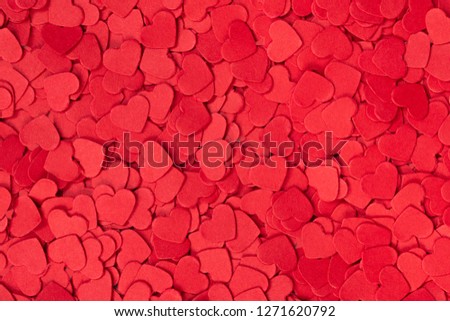 Valentine's background made of red paper hearts.