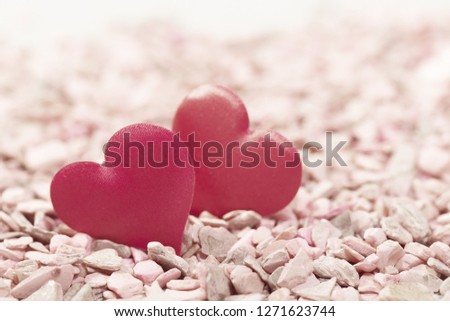 Two hearts on pink stones. Concept of love for Valentine's Day