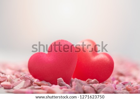 Two hearts on pink stones. Concept of love for Valentine's Day