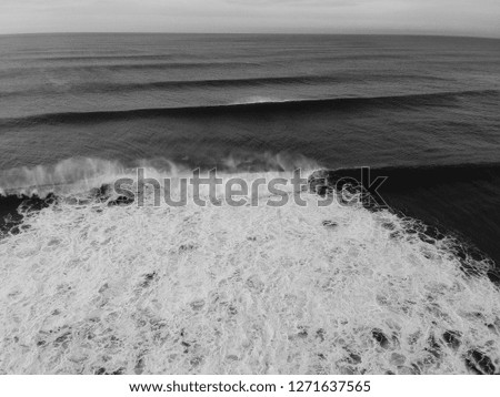 Perfect waves in a surf spot at the sunset. Aerial view. Drone shot.