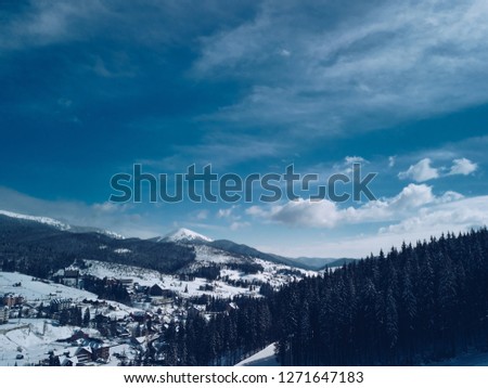 Aerial drone landscape photo of Caprathian mountains forest covered with snow,shot from above with flying camera 
