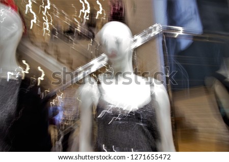 Tribute to Ernst Hass, Tribute to Monet, Ghostly figures mannequins in illuminated showcase, photographic sweeps at low shutter speed,  feeling of having life, shopping night street Toledo, Spain