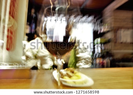 Tribute to Ernst Hass, Tribute to Monet, impressionist photograph of the people in drinking and alternating in bars of Toledo, Spain, photographic sweeps at low shutter speed, feeling of movement,